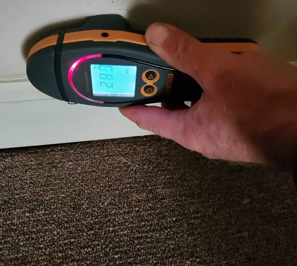 Moisture detection at baseboard during Storm Damage Restoration in Rancho Santa Margarita